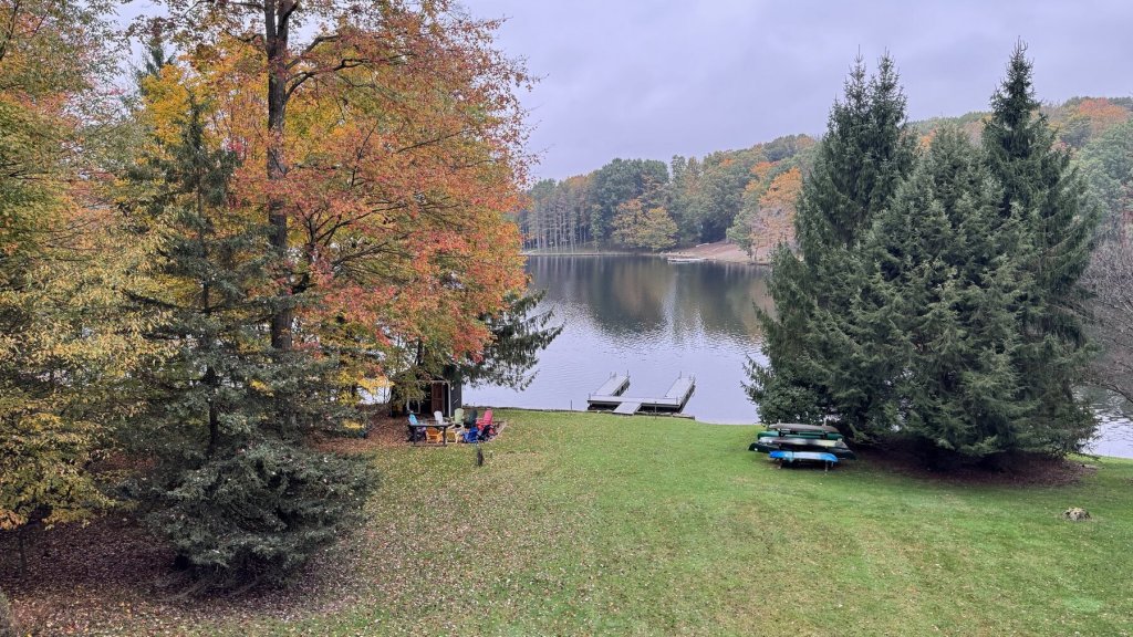 Soft gray morning light over Treasure Lake with fall colors and tall pines