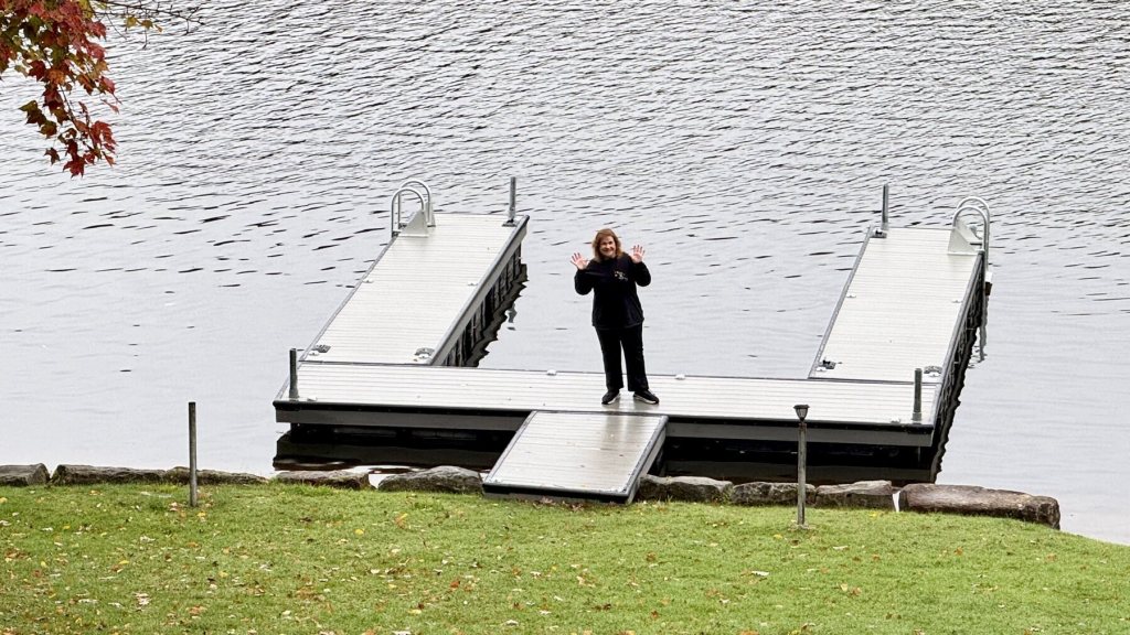 A wave from the end of the dock on a calm gray morning at Treasure Lake