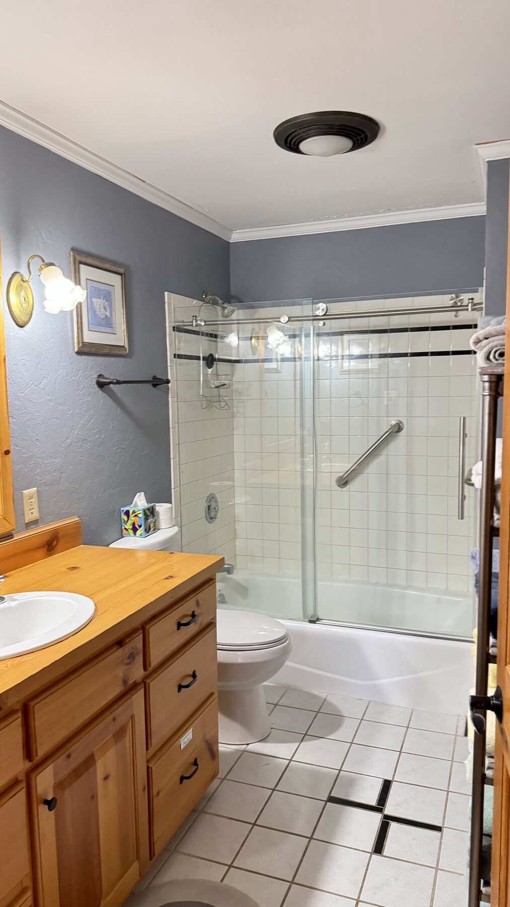 Bathroom with a glass walk-in shower and pine vanity