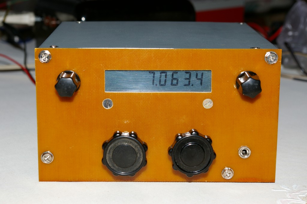A homebuilt direct-conversion shortwave receiver in an orange metal case with a digital frequency display and two knobs