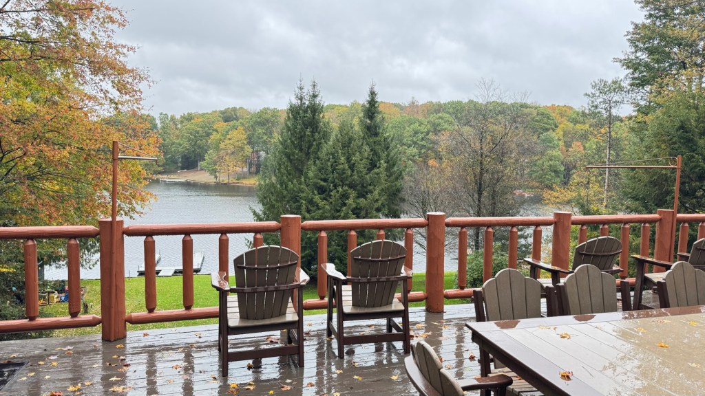 Wet deck chairs facing Treasure Lake on a rainy morning