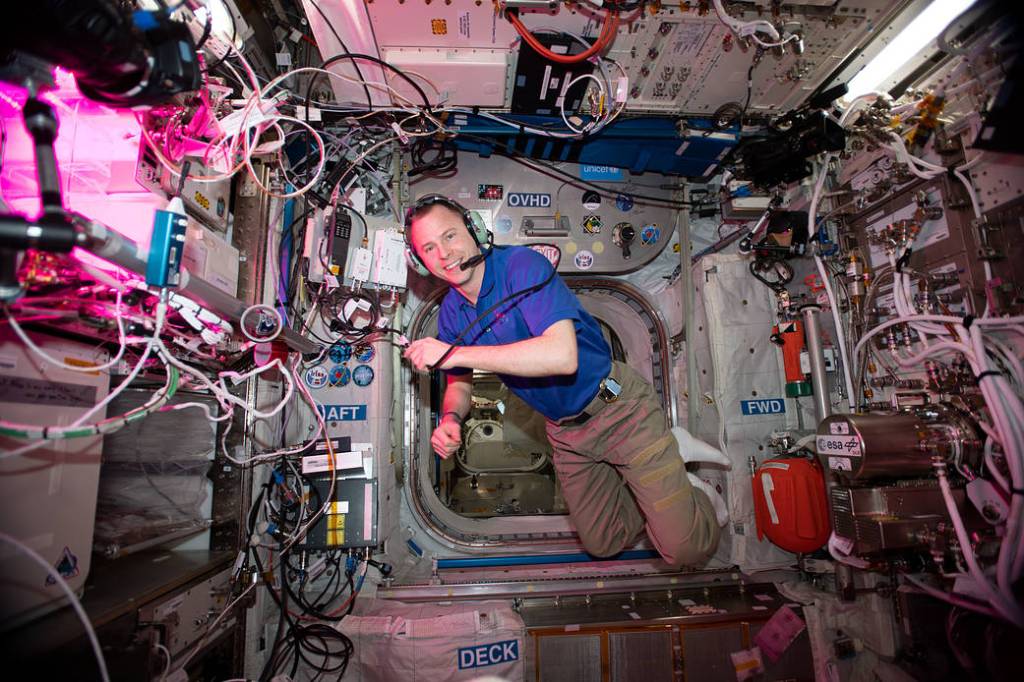 NASA astronaut Nick Hague floating inside the Columbus laboratory module of the International Space Station during an amateur radio session