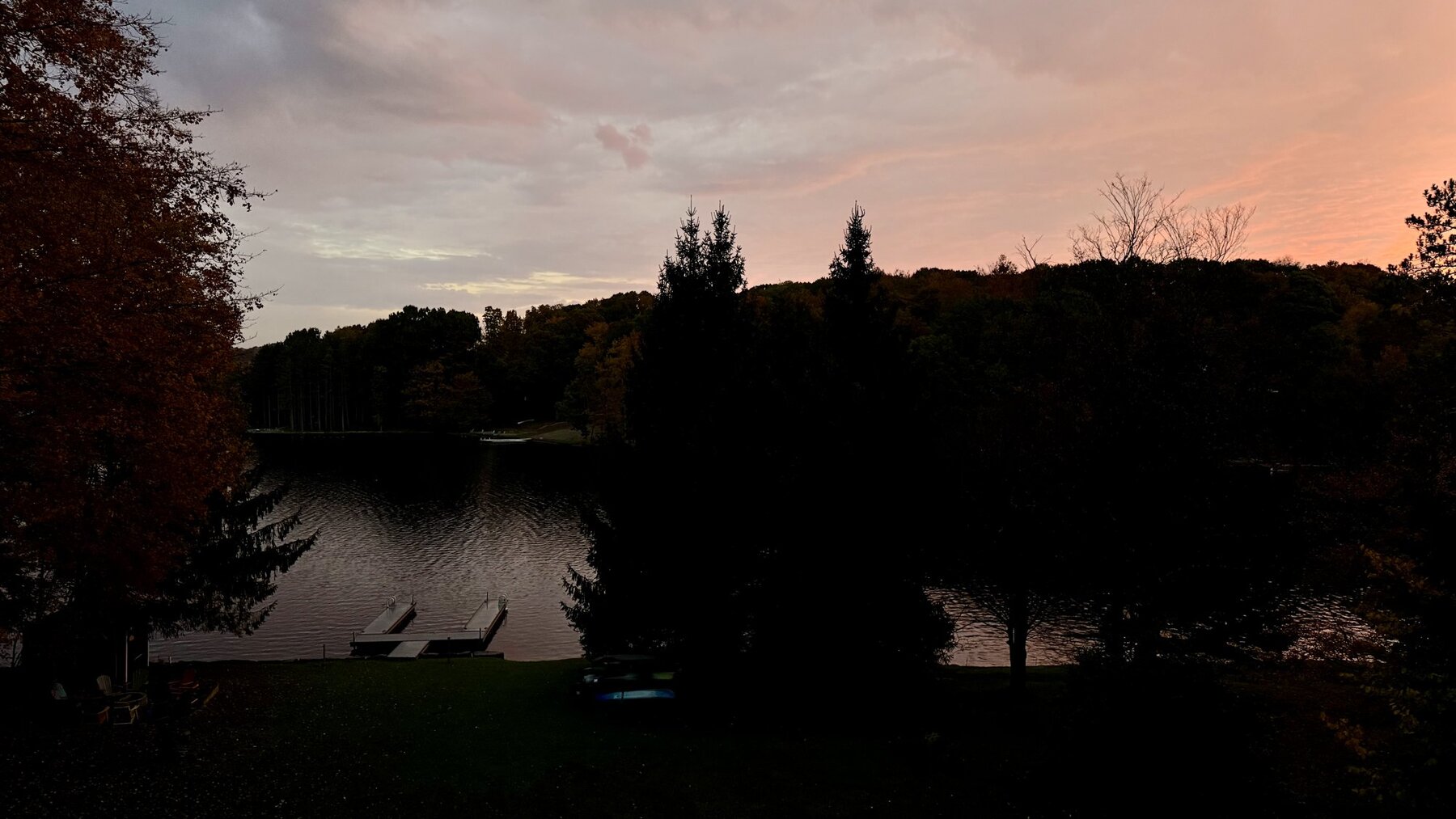 Sunrise sky over the lake with the trees in silhouette