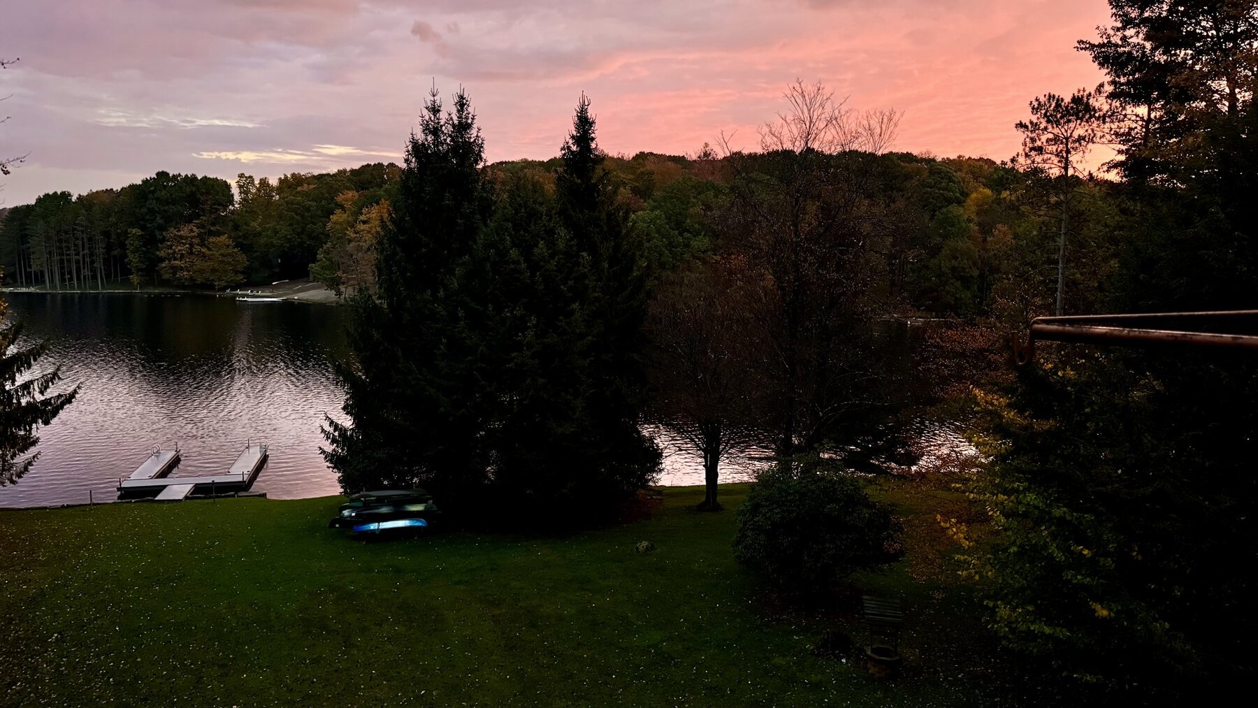 Pink sunrise over Treasure Lake with the dock and pine trees